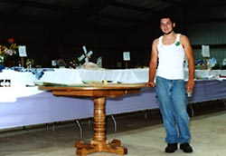 wooden table and young man who made it